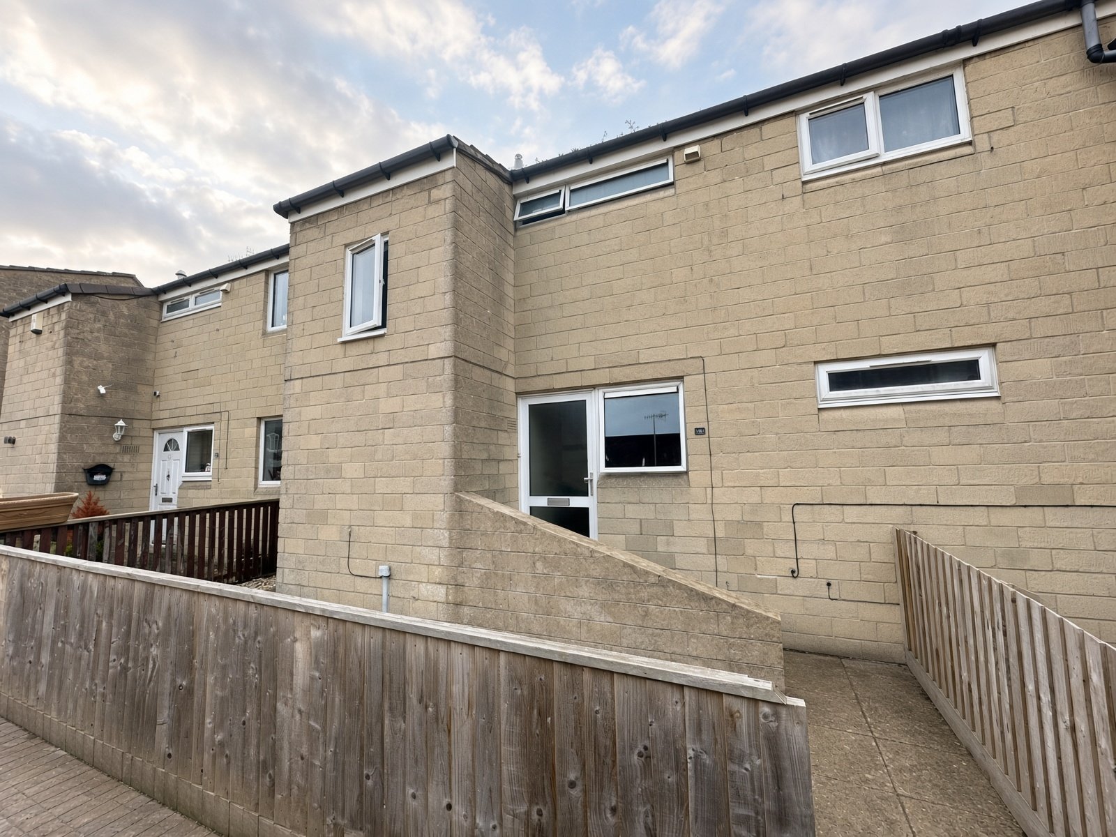 Front of 14 Rooksbridge Walk, pale stone terrace with a fenced front path