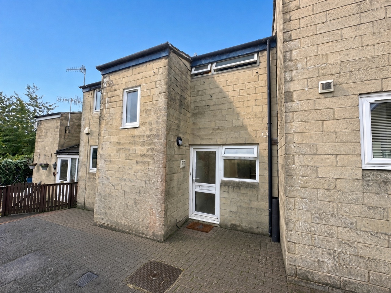 Front of 17 King George's Road, pale stone with a white door numbered 17