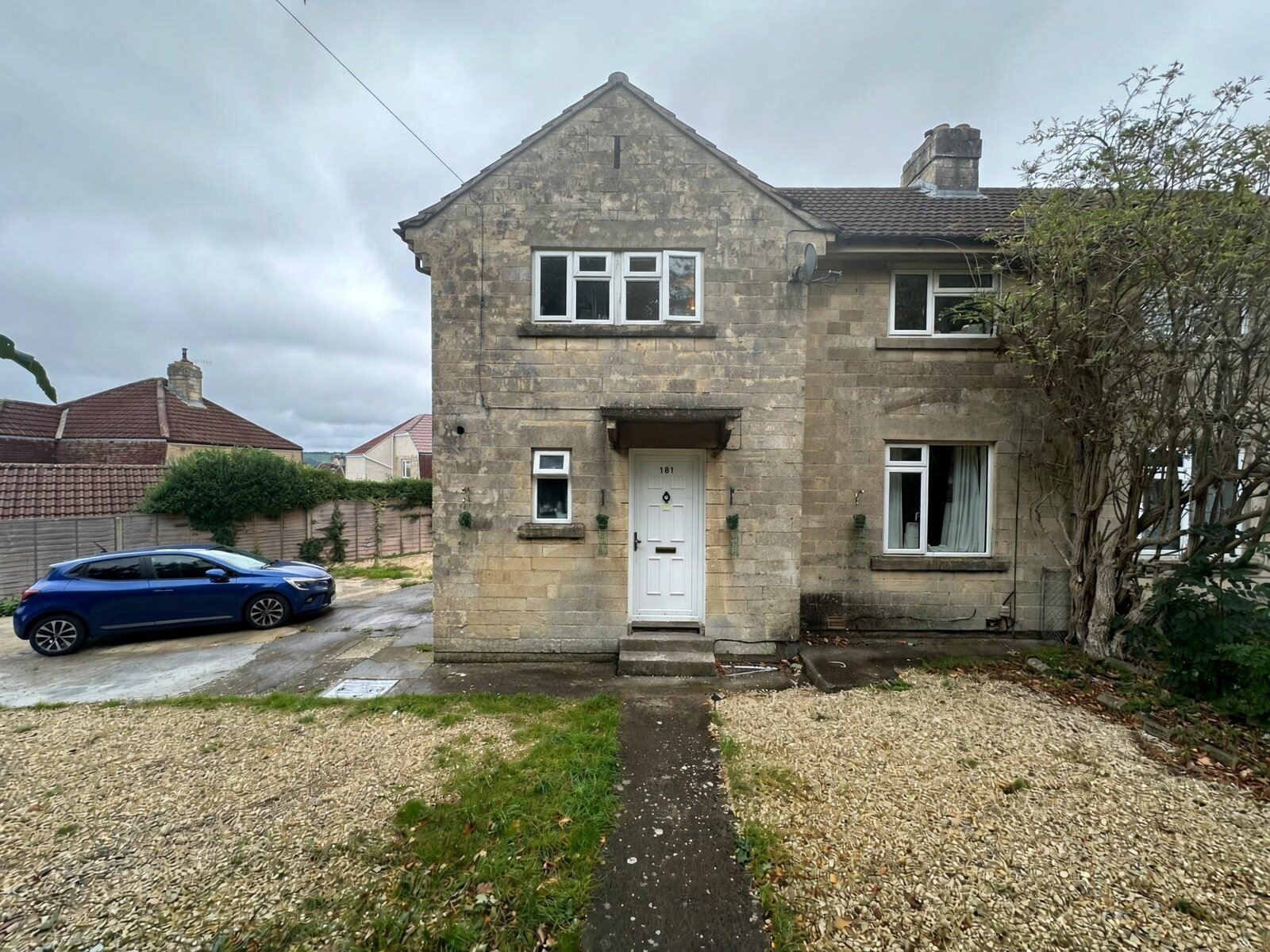 Front of 181 Haycombe Drive, stone semi-detached house with path to the front door