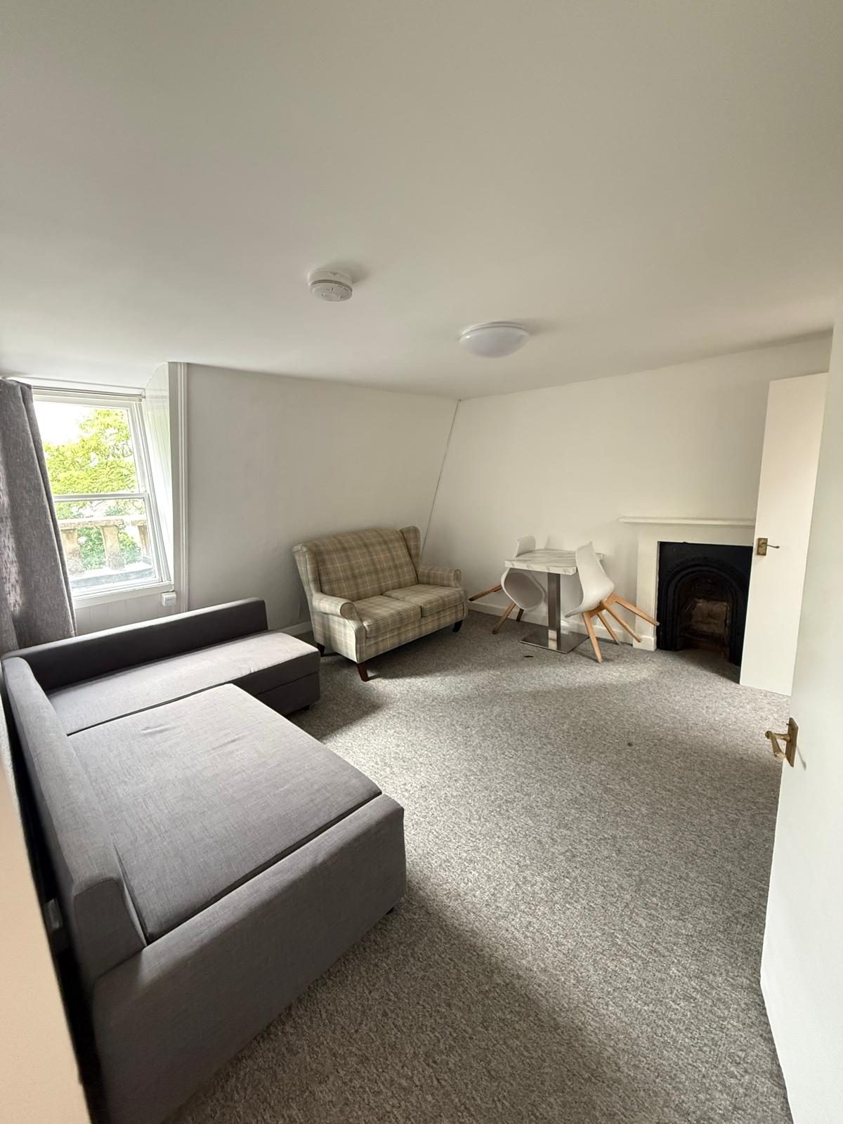 Living room at Flat 9, 34 Grosvenor Place with sofa, armchair and window